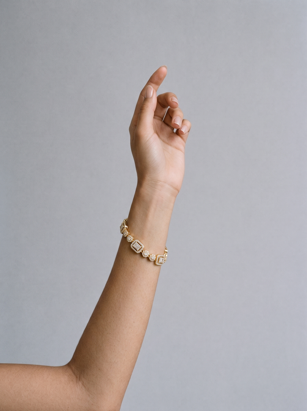 Delya Drop Bracelet gold worn on model's wrist