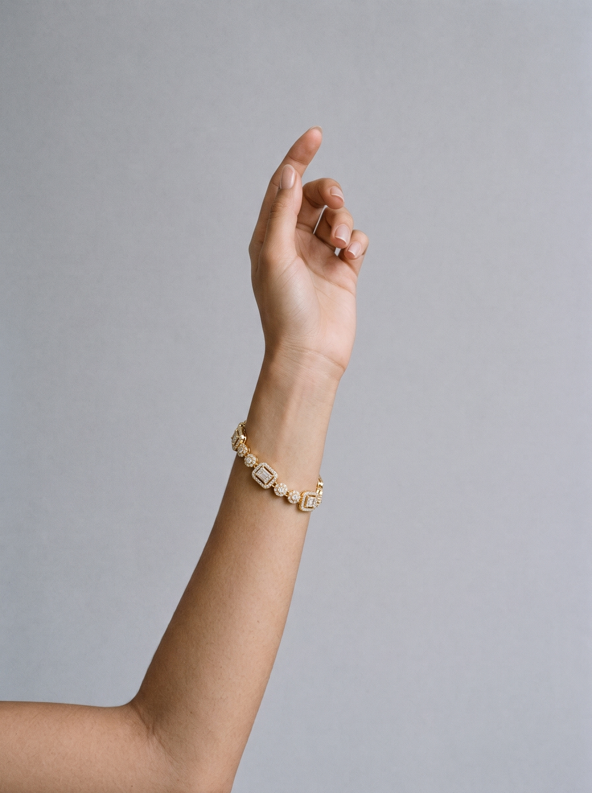 Delya Drop Bracelet gold worn on model's wrist